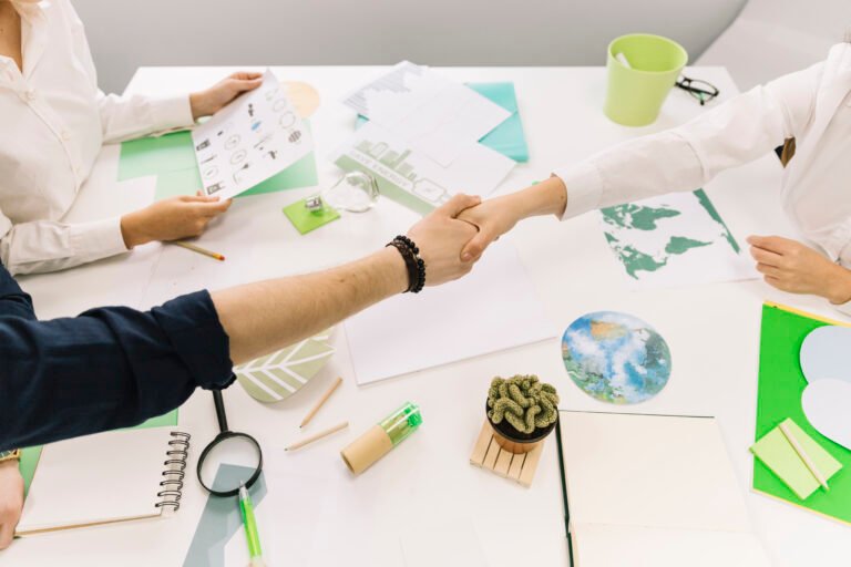 businessman-shaking-hands-with-his-partner-desk